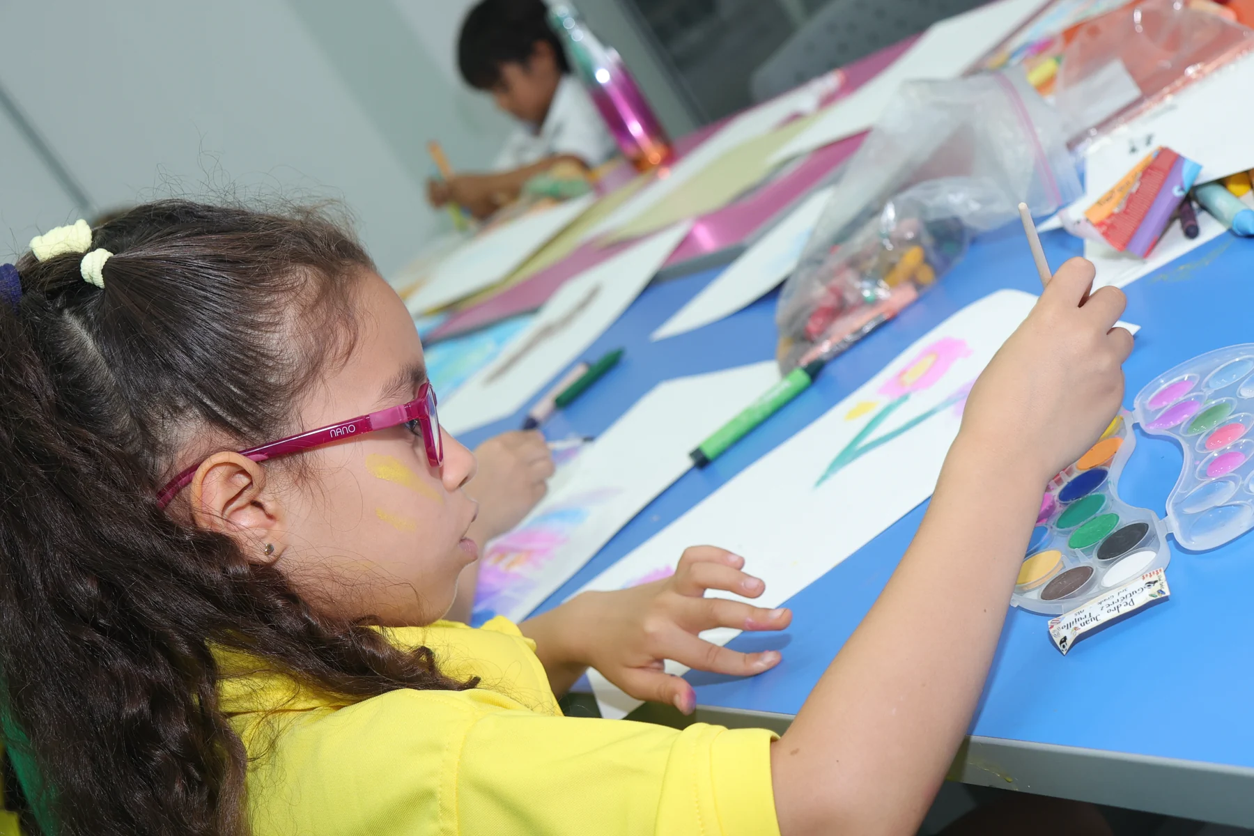Altamira student painting during an after-school art activity